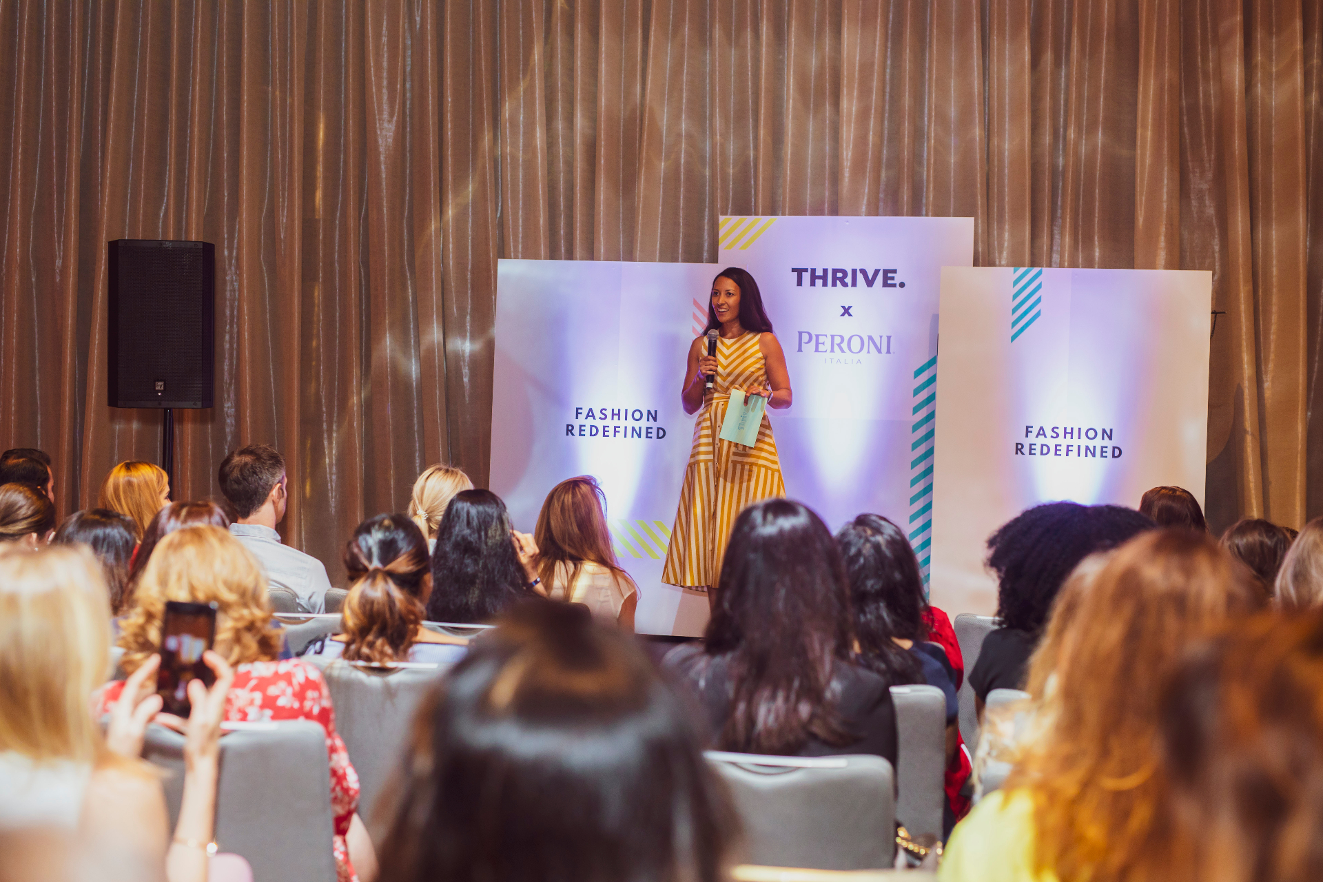 Farida facilitating a session in front of a live audience